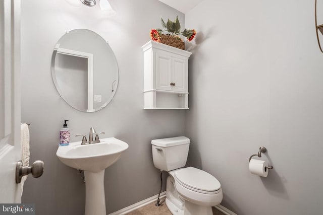  - bathroom featuring toilet and baseboards