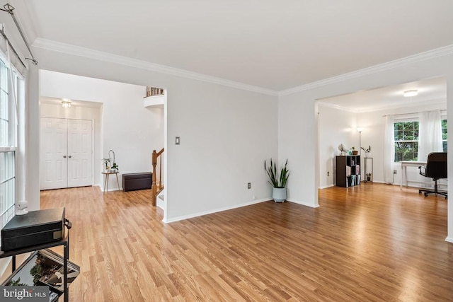  - living room featuring ornamental molding, light wood-type flooring, and stairs