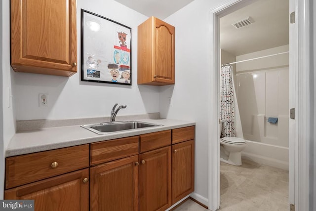  - kitchen featuring light countertops and brown cabinets