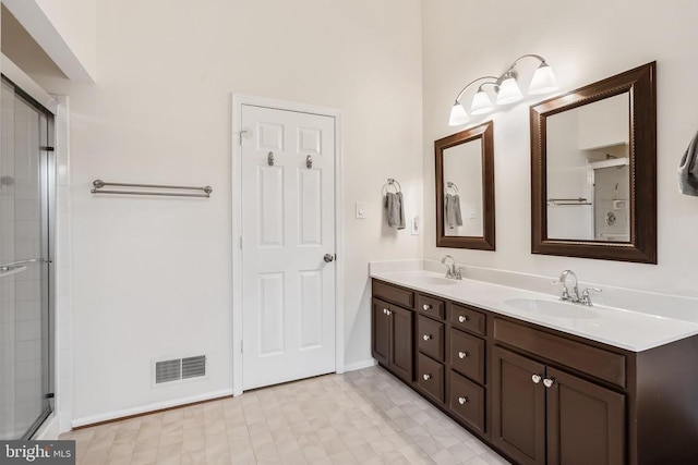  - full bath featuring double vanity and a tile shower