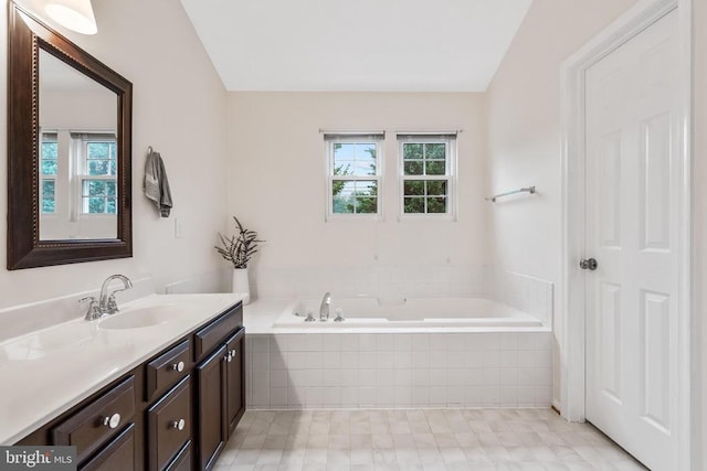  - full bathroom featuring vanity, a garden tub, plenty of natural light, and vaulted ceiling