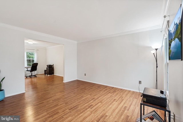  - unfurnished living room featuring crown molding, light wood-style floors, and a desk