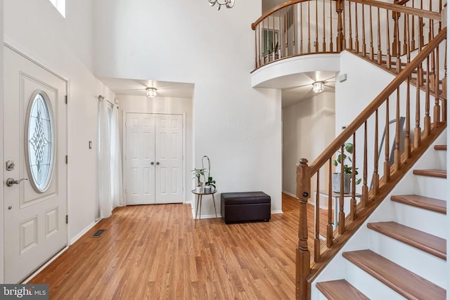  - entrance foyer with a high ceiling, wood finished floors, and stairs