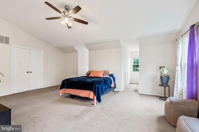  - carpeted bedroom with vaulted ceiling and a ceiling fan