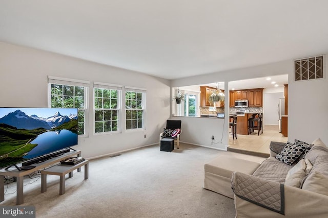  - living area featuring light carpet, a chandelier, and recessed lighting