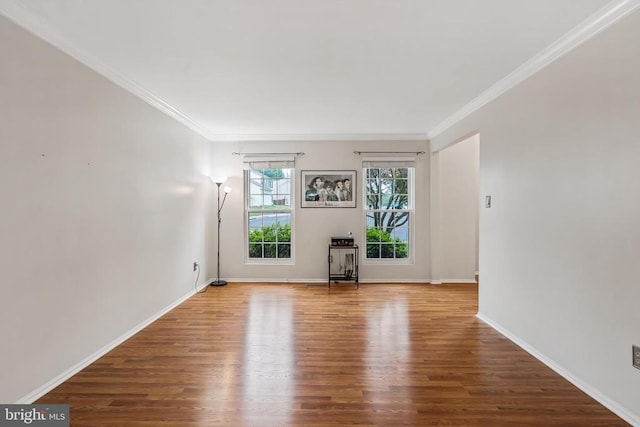  - unfurnished living room with wood finished floors and crown molding