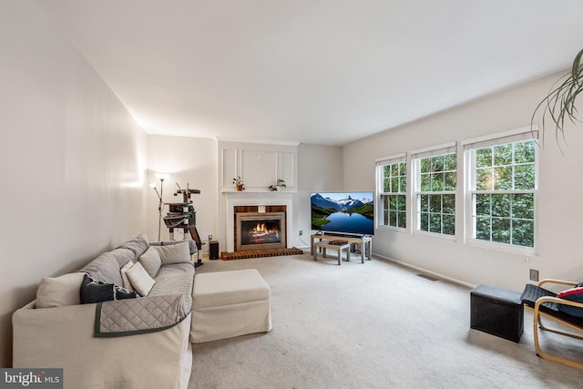  - carpeted living room featuring a fireplace