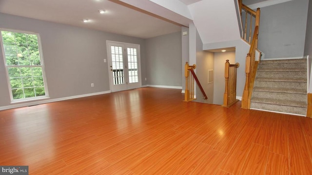 4605 Club Cart Cir, Fredericksburg, VA 22408 - unfurnished living room with healthy amount of natural light, wood finished floors, recessed lighting, and stairway