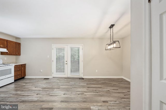 5122 Redbud Rd, Fredericksburg, VA 22407 - kitchen with white electric range, light wood-type flooring, french doors, brown cabinets, and hanging light fixtures