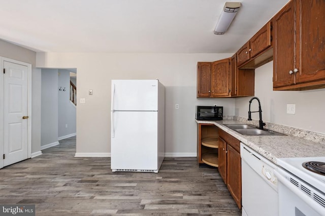 5122 Redbud Rd, Fredericksburg, VA 22407 - kitchen featuring white appliances, wood finished floors, light countertops, and brown cabinetry