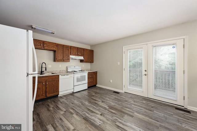 5122 Redbud Rd, Fredericksburg, VA 22407 - kitchen with white appliances, under cabinet range hood, french doors, dark wood finished floors, and light countertops