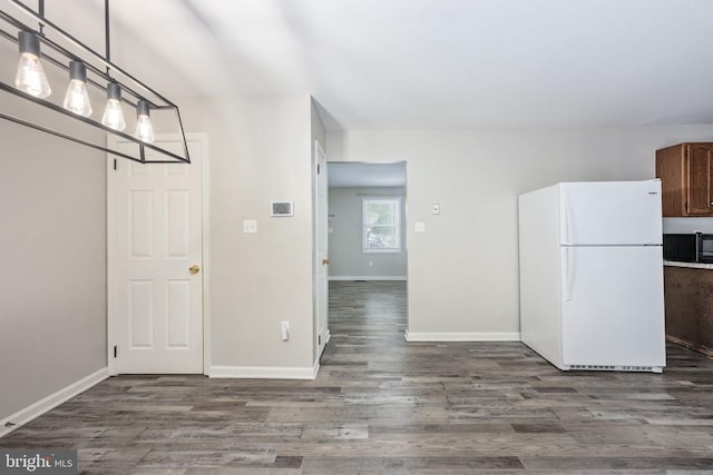 5122 Redbud Rd, Fredericksburg, VA 22407 - kitchen featuring freestanding refrigerator, black microwave, wood finished floors, and decorative light fixtures