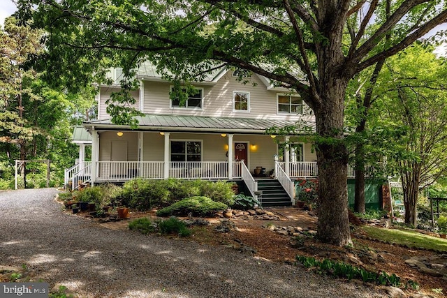 5864 Wyant Ln, Charlottesville, VA 22903 - country-style home featuring covered porch, stairway, metal roof, and a standing seam roof
