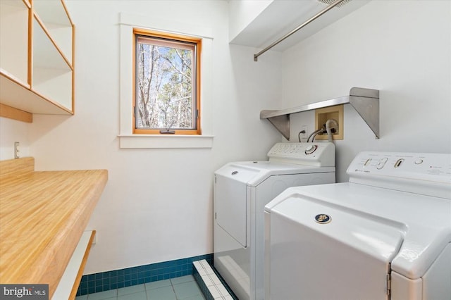 5864 Wyant Ln, Charlottesville, VA 22903 - washroom with washing machine and dryer, cabinet space, baseboards, and tile patterned flooring