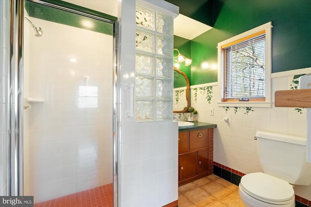 5864 Wyant Ln, Charlottesville, VA 22903 - bathroom featuring tile walls, a stall shower, vanity, toilet, and tile patterned flooring