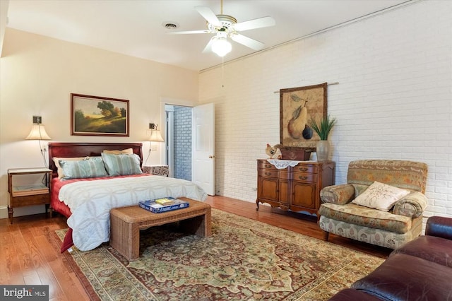 5864 Wyant Ln, Charlottesville, VA 22903 - bedroom featuring brick wall, wood finished floors, and ceiling fan