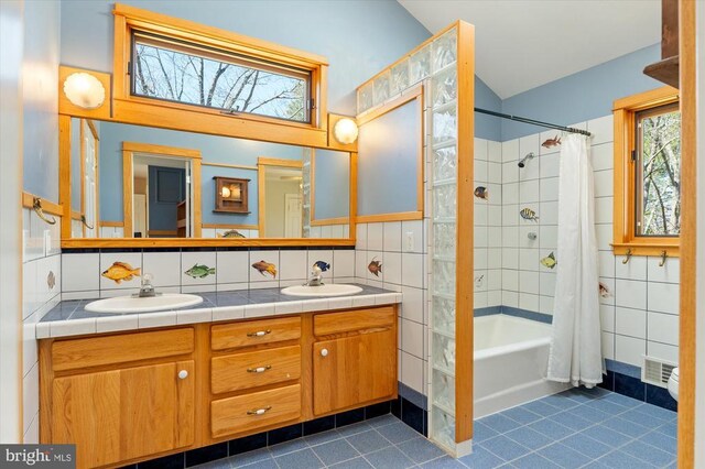 5864 Wyant Ln, Charlottesville, VA 22903 - bathroom with tile walls, tile patterned flooring, lofted ceiling, shower / tub combo with curtain, and double vanity