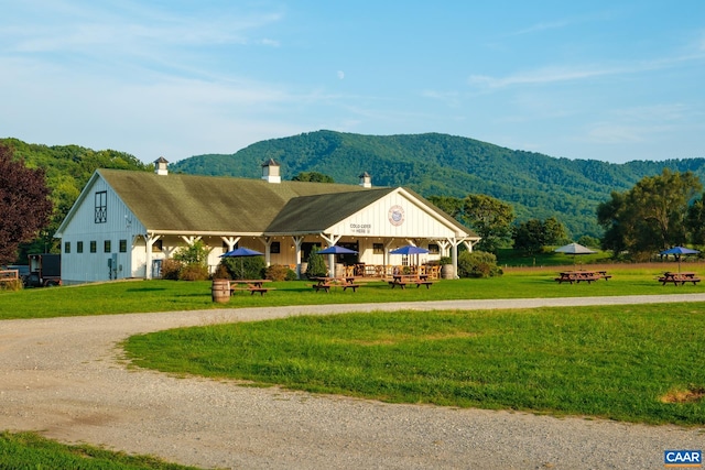 462 Winery Ln, Nellysford, VA 22958 - view of front of house featuring curved driveway, a chimney, a mountain view, and a front yard