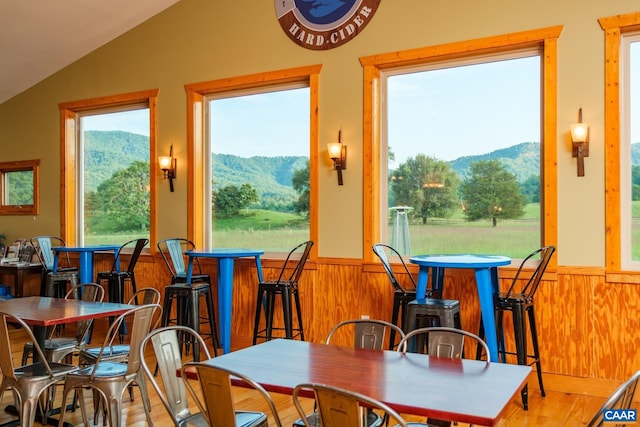 462 Winery Ln, Nellysford, VA 22958 - dining space with wood finished floors, a mountain view, a wainscoted wall, and vaulted ceiling