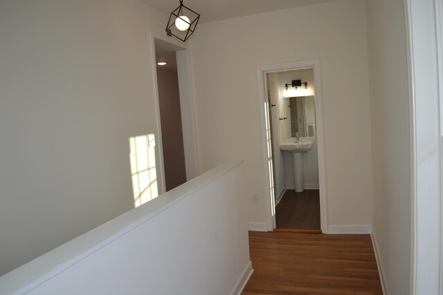 307 2nd St, Shenandoah, VA 22849 - corridor featuring dark wood-type flooring, an upstairs landing, baseboards, and a sink