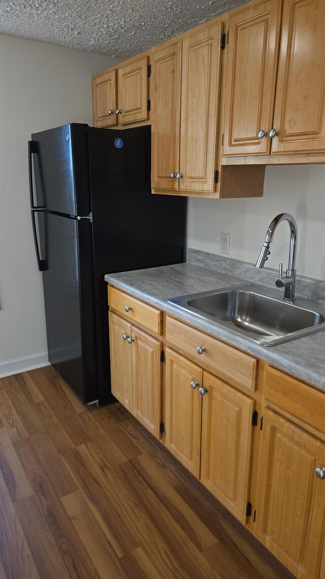 307 2nd St, Shenandoah, VA 22849 - kitchen with a sink, freestanding refrigerator, dark wood finished floors, a textured ceiling, and light countertops