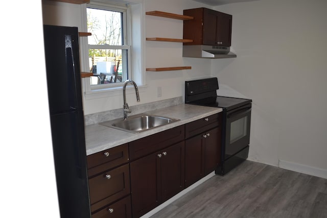 kitchen featuring black appliances, a sink, dark brown cabinets, open shelves, and light countertops