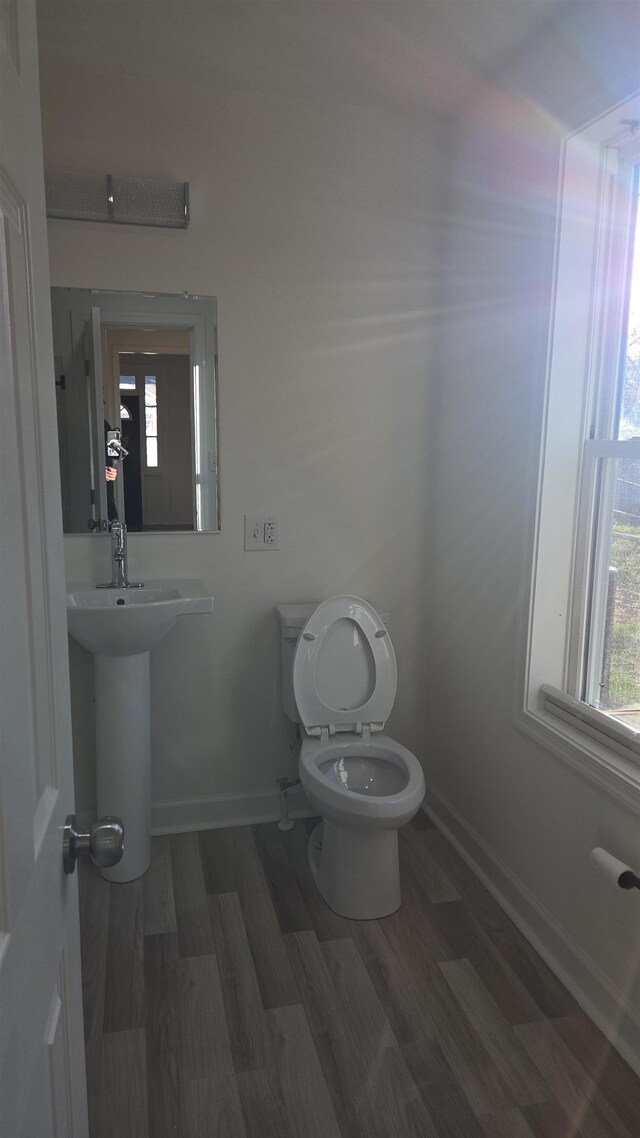 307 2nd St, Shenandoah, VA 22849 - half bathroom featuring wood finished floors, baseboards, and toilet