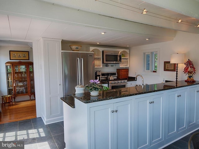 435 Larkins Mill Ln, Brightwood, VA 22715 - kitchen with dark tile patterned floors, a sink, dark stone counters, arched walkways, and appliances with stainless steel finishes