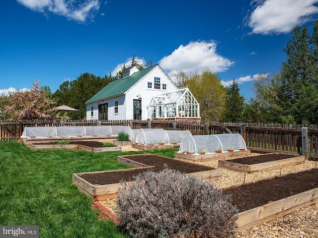 435 Larkins Mill Ln, Brightwood, VA 22715 - rear view of house with a yard, metal roof, a garden, and a fenced backyard