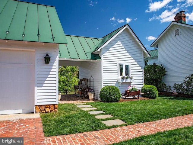 435 Larkins Mill Ln, Brightwood, VA 22715 - rear view of property featuring a lawn, metal roof, a standing seam roof, and a garage