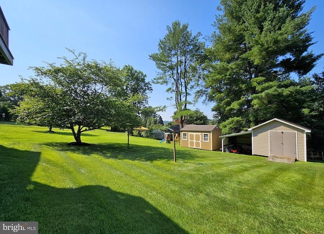336 Blankenbaker Rd, Madison, VA 22727 - view of grassy yard with a shed, a playground, and a carport
