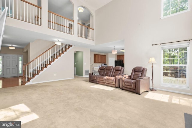 3113 Somerset Dr, Jeffersonton, VA 22724 - carpeted living room featuring a high ceiling, stairway, and plenty of natural light