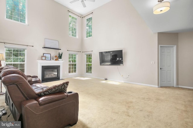 3113 Somerset Dr, Jeffersonton, VA 22724 - living area with carpet flooring, a high ceiling, ceiling fan, and a fireplace with flush hearth