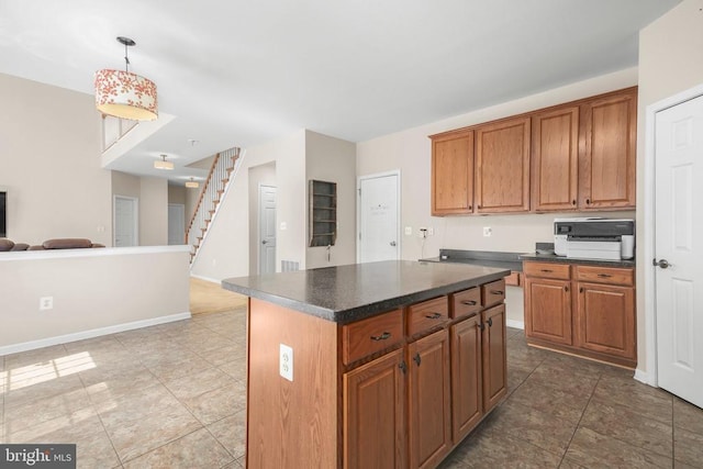 3113 Somerset Dr, Jeffersonton, VA 22724 - kitchen featuring open floor plan, dark countertops, tile patterned flooring, brown cabinets, and a kitchen island