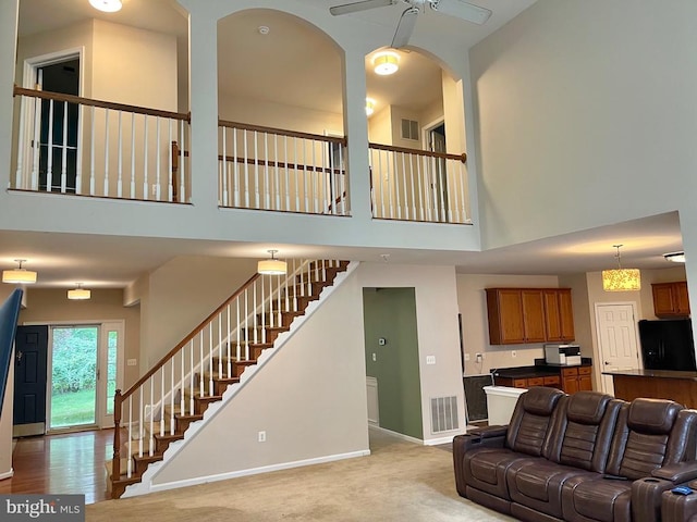 3113 Somerset Dr, Jeffersonton, VA 22724 - carpeted living area with a towering ceiling, ceiling fan, and stairs