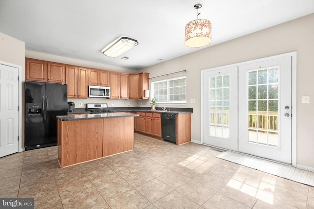 3113 Somerset Dr, Jeffersonton, VA 22724 - kitchen with black appliances, dark countertops, a kitchen island, brown cabinets, and decorative light fixtures