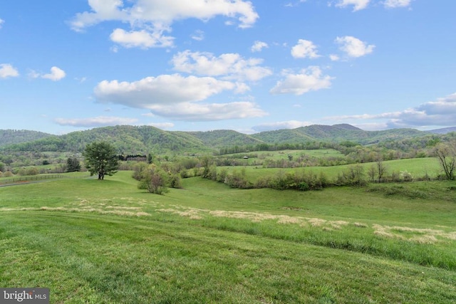  - view of mountain backdrop featuring rural landscape