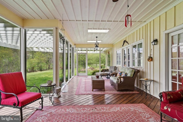  - sunroom featuring a ceiling fan