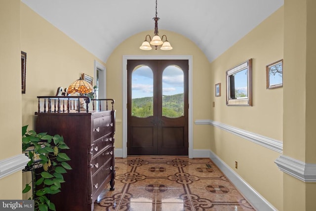  - tiled foyer entrance with a chandelier, healthy amount of natural light, baseboards, and lofted ceiling