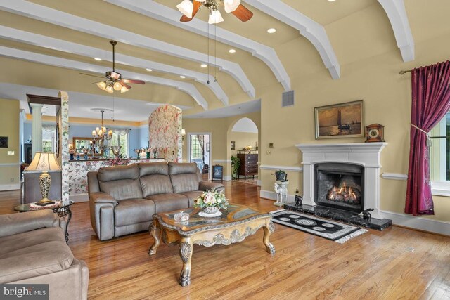  - living area featuring a ceiling fan, recessed lighting, wood finished floors, a lit fireplace, and baseboards