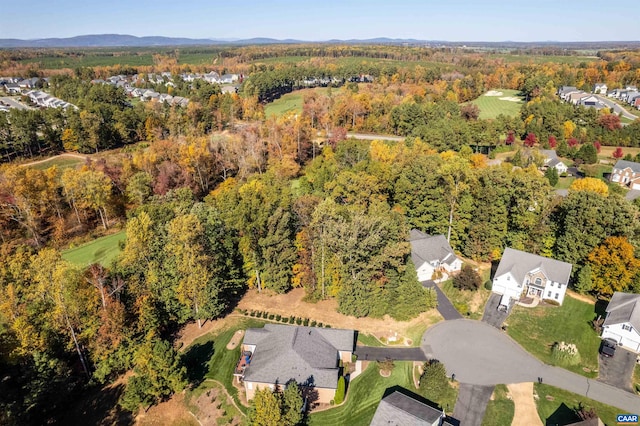 birds eye view of property featuring a residential view and a wooded view