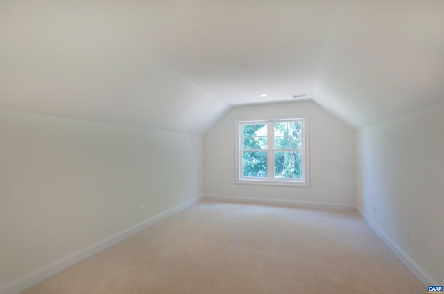 bonus room featuring vaulted ceiling, baseboards, and light carpet