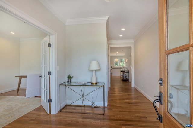 hallway featuring ornamental molding, french doors, and wood finished floors