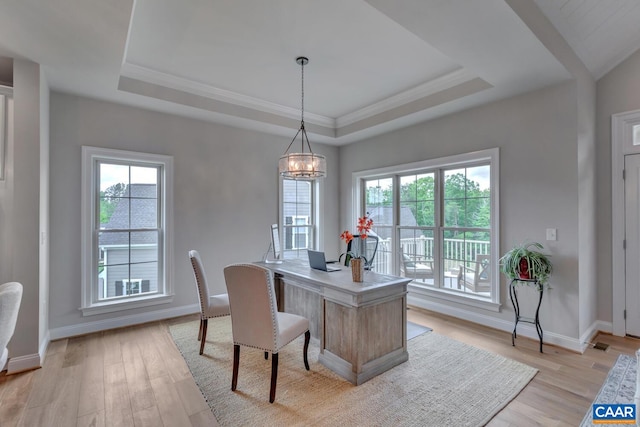 home office featuring a wealth of natural light, baseboards, and light wood-type flooring