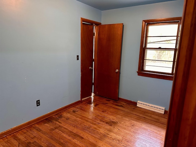 unfurnished room with wood finished floors and baseboards