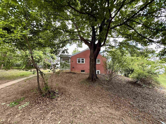 view of home's exterior with brick siding