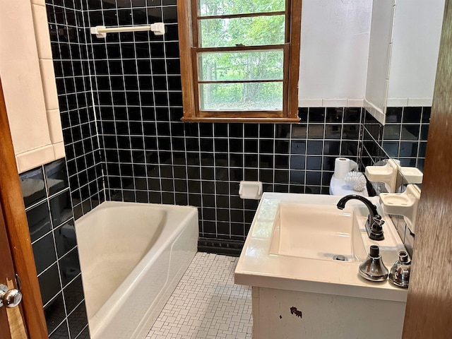 bathroom featuring tile walls, tile patterned floors, and vanity