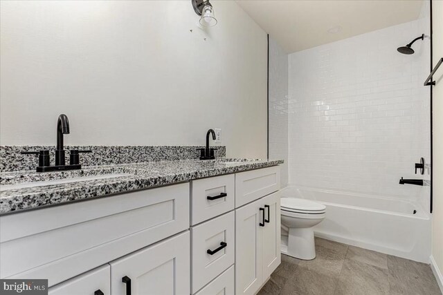full bath featuring toilet, double vanity, washtub / shower combination, and tile patterned flooring