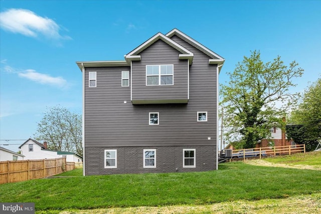 back of property featuring cooling unit and brick siding