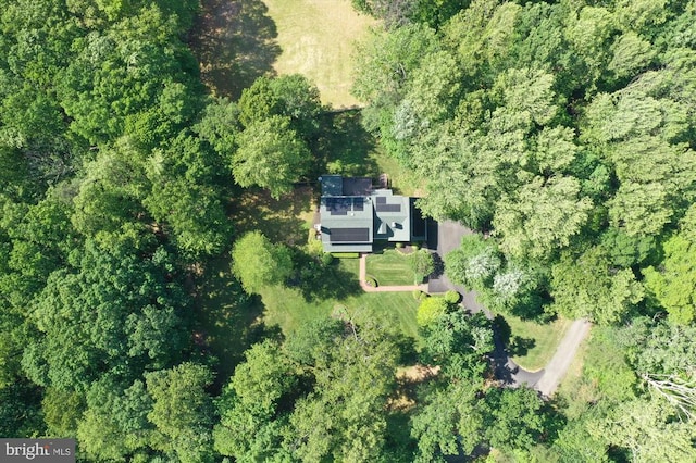  - aerial overview of property's location with a heavily wooded area